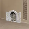 A cat is looking out of a white cat door installed in a wall. Náhled obrázku produktu