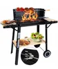 A charcoal grill with food cooking on it, set up outdoors. Produktbild-Vorschau