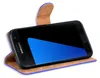 A black Samsung Galaxy S7 phone in a purple and brown flip case, displayed diagonally against a white background. Produktbild-Vorschau