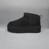 A black UGG boot with a platform sole is shown against a plain gray background. Voir les images du produit