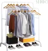 A white metal garment rack with clothes hanging on it, and some items on the lower shelves. Podgląd zdjęcia produktu