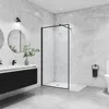 A modern bathroom with a walk-in shower, vanity, and toilet. Produktbild-Vorschau