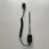 A black coiled power cord with a plug and a silver heating element with a black control knob are laid out on a light gray surface. Náhľad obrázku produktu