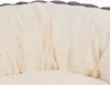 A close-up view of a soft, plush dog bed with a cream-colored interior and a gray border. Produktbild-Vorschau