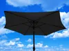 A dark gray rectangular umbrella is shown against a bright blue sky with white clouds. Produktbild-Vorschau