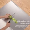 A person is cutting a bitter melon on a stainless steel cutting board, with text overlays describing the product's features. Produktbild-Vorschau