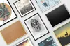 A collection of framed pictures and a corkboard arranged on a light gray surface. Produktbild-Vorschau