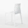 A white chair with a patterned back is shown against a white background. Produktbild-Vorschau