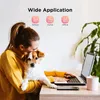 A woman is holding a dog while working on a laptop at a desk. There are icons and text above them indicating 'Wide Application' for school, home, and office. Produktbild-Vorschau