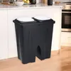 A black dual trash can with white lids sits in a kitchen setting. Anteprima dell’immagine prodotto