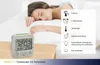 A woman sleeping in bed next to a digital alarm clock. Anteprima dell’immagine prodotto