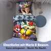 A young boy sleeping in a bed with Super Mario themed bedding. Produktbild-Vorschau