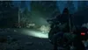 A person on a motorcycle in a dark, wooded area with abandoned vehicles. Produktbild-Vorschau