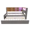 A bed frame with a pull-out trundle bed, featuring a headboard with shelves and LED lighting. Podgląd zdjęcia produktu