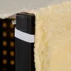 A close-up view of the corner of a dog stair with a beige fabric cover and a black plastic frame, secured by a white elastic band. Náhled obrázku produktu