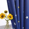 A close-up of a blue curtain with white and yellow stars, next to a vase of sunflowers. Produktbild-Vorschau