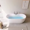 A modern white freestanding bathtub filled with blue water, with black fixtures, placed in a minimalist bathroom setting. Náhled obrázku produktu