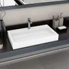 A modern white sink with a chrome faucet on a dark countertop. Náhľad obrázku produktu