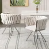 Two beige upholstered dining chairs with silver legs are placed on a grey and white striped rug in front of a white dining table. Voir les images du produit