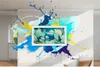 A Samsung QLED The Frame TV is mounted on a wall, surrounded by colorful paint splashes, suggesting a vibrant and artistic display. Voir les images du produit
