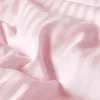 Close-up view of pink striped fabric, likely bedding. Náhled obrázku produktu