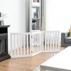A white wooden pet gate is set up in a living room, blocking off an area in front of a fireplace and bookshelf. Anteprima dell’immagine prodotto