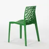 A green chair with a unique, web-like design on a white background. Produktbild-Vorschau