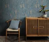 A chair with a pillow and a cabinet with a plant in a room. Náhľad obrázku produktu