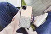 A person holding an iPhone 13 mini case with a polka dot pattern, sitting down with jeans and sneakers visible. Produktbild-Vorschau
