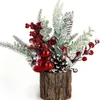 A small artificial Christmas decoration in a log holder. Produktbild-Vorschau