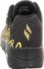 The back view of a black and gold Skechers sneaker. Voir les images du produit