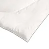 A close-up, angled view of a white duvet or comforter, showing its quilted texture and a subtle embossed logo. Produktbild-Vorschau
