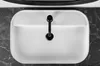 A top-down view of a white sink with a black faucet, set against a dark marble countertop. Produktbild-Vorschau