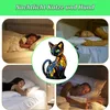 A collage of four images showing people sleeping in beds, with a central image of a stained-glass cat lamp. Produktbild-Vorschau