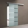 A sliding glass door with frosted panels and horizontal stripes, mounted on a track against a brown wall. Produktbild-Vorschau