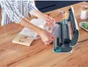 A person is using a vacuum sealer to seal food in a plastic bag on a wooden table. Náhľad obrázku produktu