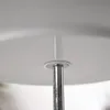 A close-up view of the central support pole of a multi-tiered serving stand, showing the connection to one of the porcelain plates. Podgląd zdjęcia produktu