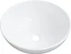 A white ceramic sink with a drain hole in the center.