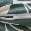A close-up of a green and white patterned fabric with a zipper. Produktbild-Vorschau