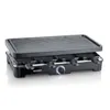 A studio shot of a black electric raclette grill with a grill top and multiple cheese pans underneath. Voir les images du produit