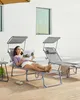 A woman is relaxing on a lounge chair outdoors, reading a magazine. Produktbild-Vorschau