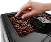 A close-up shot of a hand adjusting a dial on a coffee bean grinder. Produktbild-Vorschau