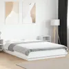 A white bed frame with bedding is shown in a bedroom setting. Produktbild-Vorschau