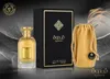 A perfume bottle, its box, and a drawstring pouch are displayed against a dark, textured background with feather-like elements. Anteprima dell’immagine prodotto