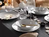 A table setting with plates, bowls, cutlery, and glasses, decorated with small wooden discs. Náhľad obrázku produktu