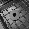 A close-up view of a black rubber car mat with a grid pattern, with a single black rubber washer placed on top. Anteprima dell’immagine prodotto