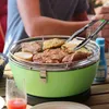 People are grilling food on a table. Produktbild-Vorschau