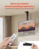 A TV mount is shown in use, with a remote control in hand and a wired controller on a surface. Produktbild-Vorschau