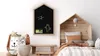 A child's bedroom with a house-shaped chalkboard and bed. Produktbild-Vorschau