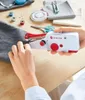 A person is using a handheld sewing machine to sew fabric. Náhled obrázku produktu